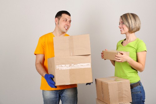 Removal staff carrying furniture through a central London property in Belgravia